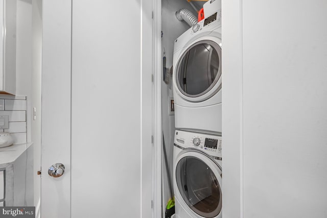 laundry area with laundry area and stacked washer and clothes dryer