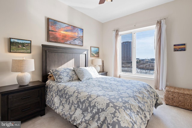 bedroom featuring light colored carpet and ceiling fan