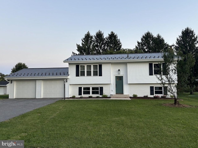 bi-level home featuring a garage and a front yard