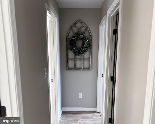 corridor with light hardwood / wood-style flooring