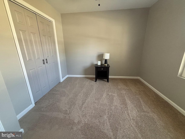 unfurnished bedroom with carpet flooring and a closet