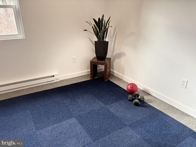 exercise area featuring carpet flooring and baseboard heating