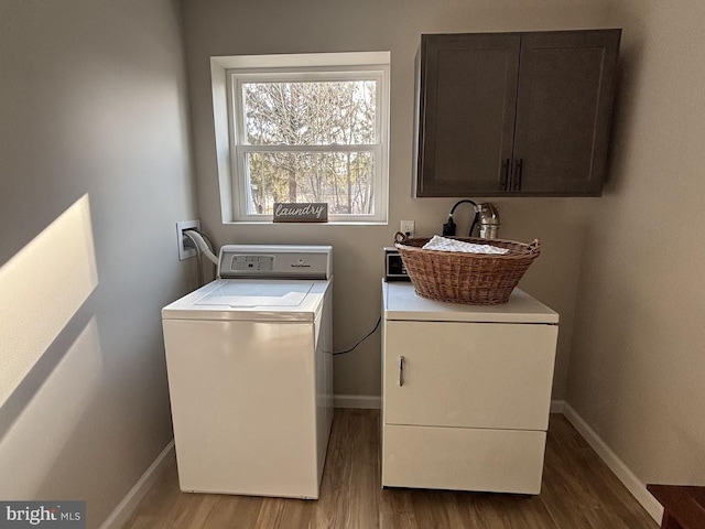 laundry room with cabinets, dark hardwood / wood-style flooring, separate washer and dryer, and sink