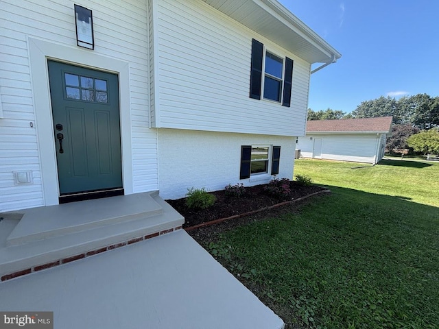 entrance to property with a lawn