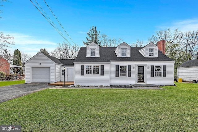 cape cod house featuring a garage and a front lawn