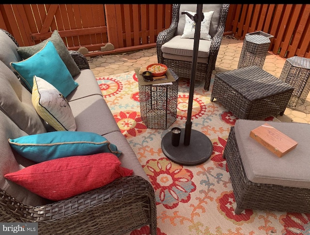 view of patio / terrace featuring outdoor lounge area and fence