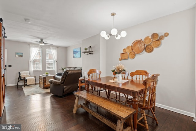 dining space with dark hardwood / wood-style floors and ceiling fan with notable chandelier