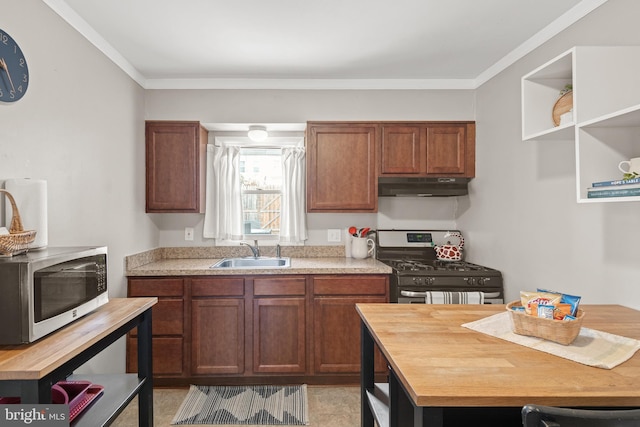 kitchen with ornamental molding, appliances with stainless steel finishes, wood counters, and sink