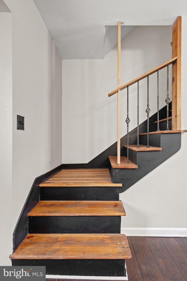 staircase featuring hardwood / wood-style flooring