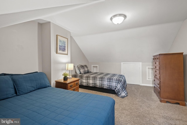 carpeted bedroom with lofted ceiling