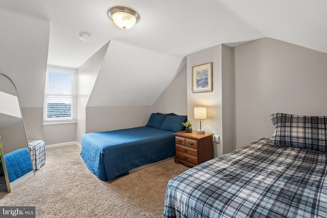 bedroom featuring vaulted ceiling and carpet