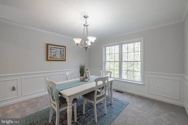 dining area featuring crown molding, light colored carpet, and a notable chandelier