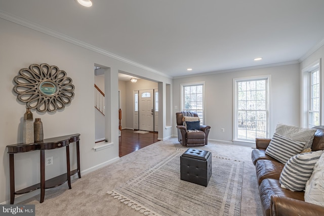 carpeted living room featuring ornamental molding