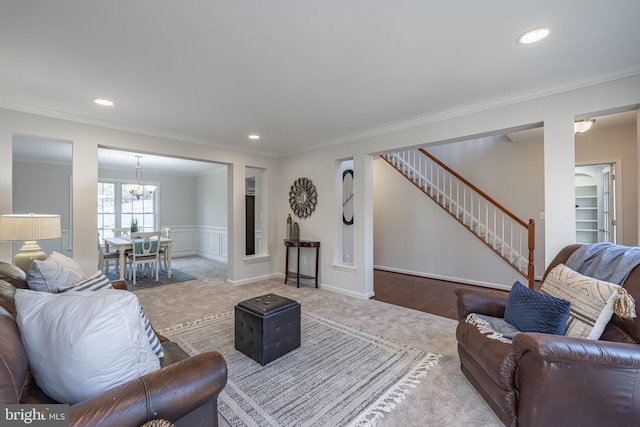 carpeted living room featuring an inviting chandelier and ornamental molding