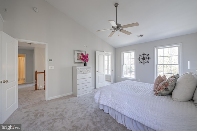 carpeted bedroom featuring ceiling fan and high vaulted ceiling