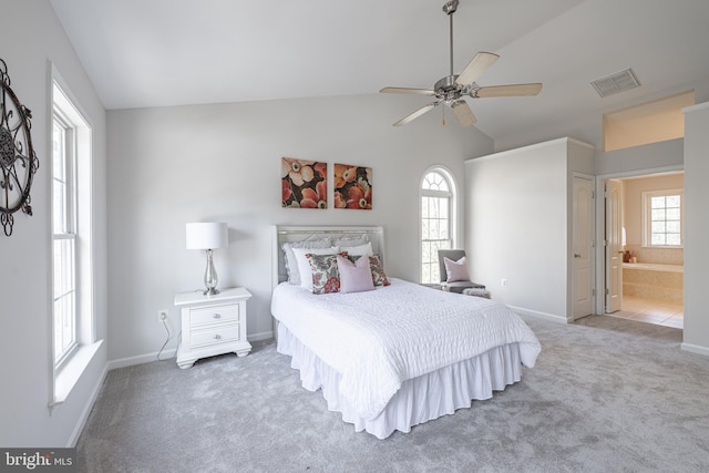 bedroom with vaulted ceiling, ensuite bathroom, ceiling fan, and carpet