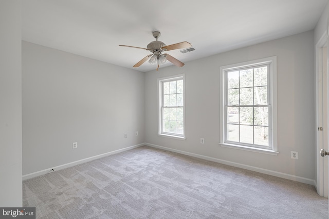 carpeted spare room featuring ceiling fan