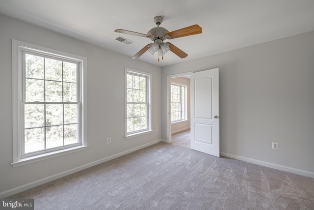 carpeted empty room with ceiling fan