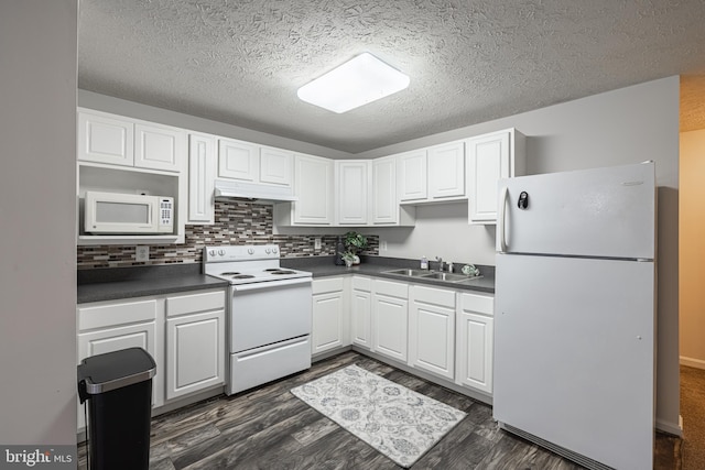 kitchen with sink, white appliances, white cabinetry, dark hardwood / wood-style floors, and decorative backsplash