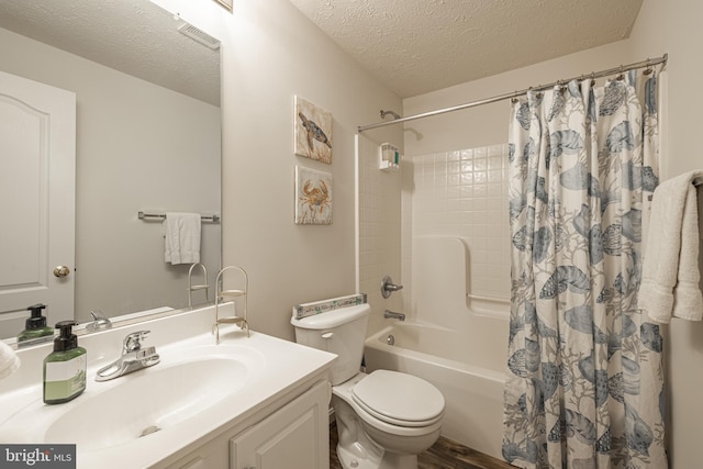 full bathroom featuring vanity, toilet, shower / tub combo, and a textured ceiling