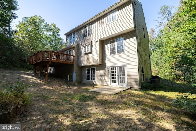 rear view of house featuring a deck and a patio area