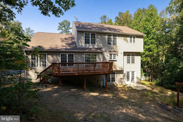 rear view of property with a wooden deck