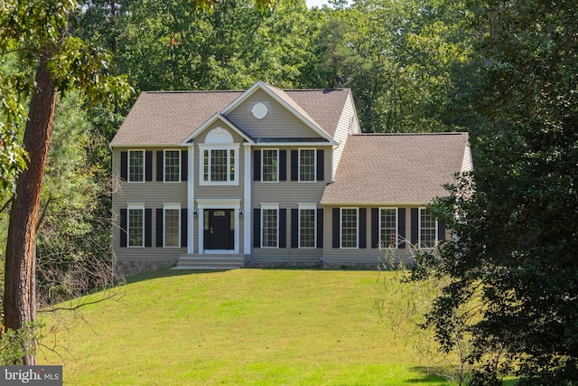 colonial home with a front lawn