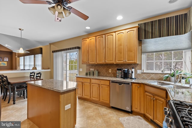 kitchen featuring pendant lighting, sink, appliances with stainless steel finishes, tasteful backsplash, and light stone countertops