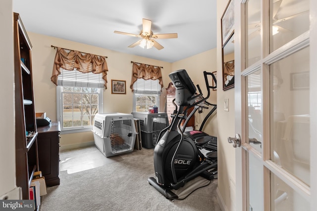 workout area with light colored carpet and ceiling fan