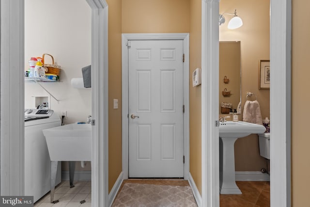 bathroom featuring washer / clothes dryer and tile patterned flooring