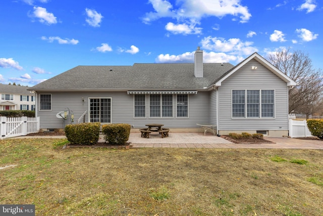 rear view of property featuring a lawn and a patio area