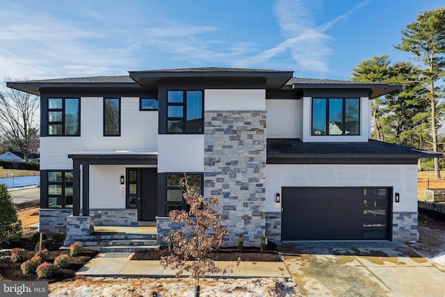 view of front facade with an attached garage and stone siding