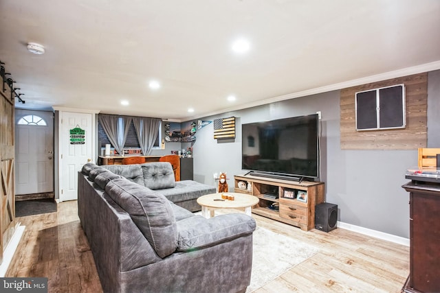 living room with ornamental molding and light wood-type flooring