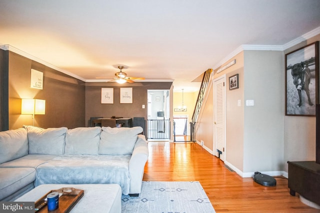 living room featuring crown molding, ceiling fan, and hardwood / wood-style floors