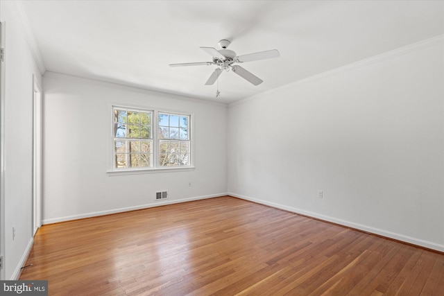 spare room with light hardwood / wood-style flooring, ceiling fan, and ornamental molding