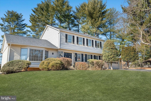 view of front facade with a garage and a front lawn