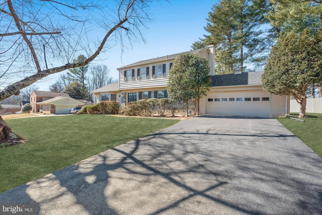 view of front of house with a front yard and a garage