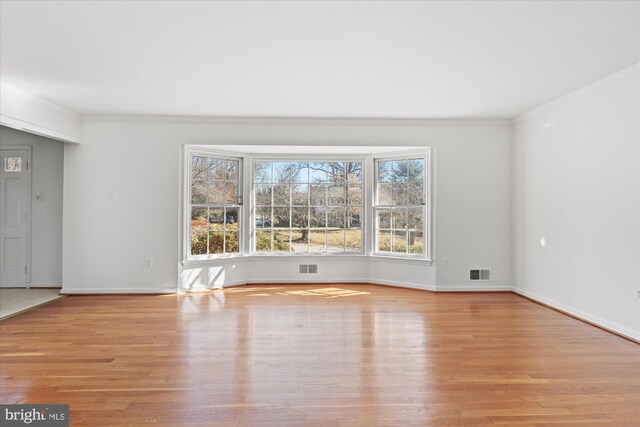 interior space featuring light hardwood / wood-style flooring and ornamental molding