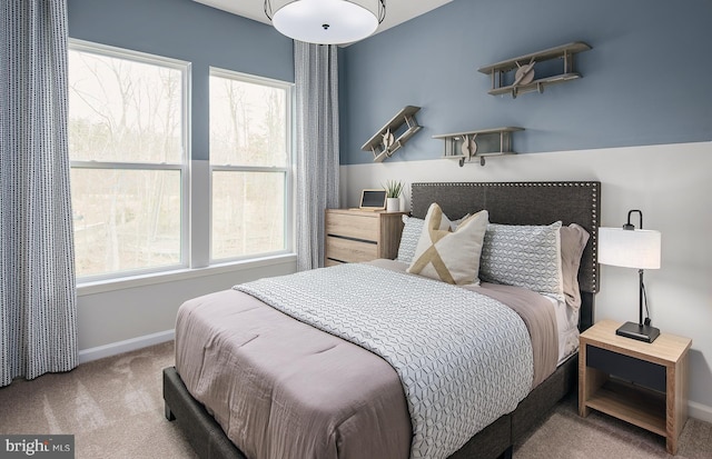 carpeted bedroom featuring multiple windows