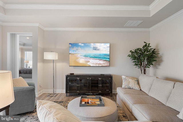 living room with hardwood / wood-style flooring and ornamental molding