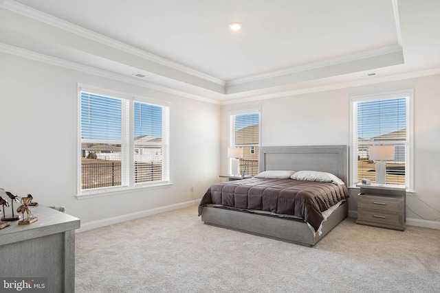 bedroom with light carpet, multiple windows, and a raised ceiling