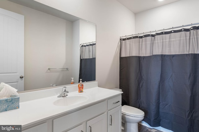 bathroom featuring vanity, toilet, and a shower with shower curtain