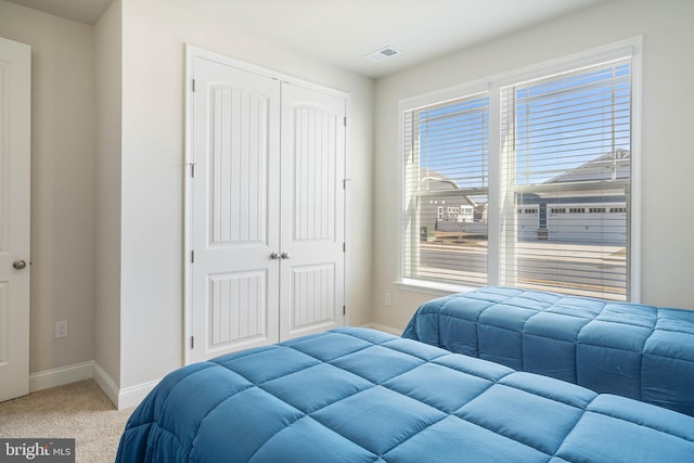 carpeted bedroom with a closet