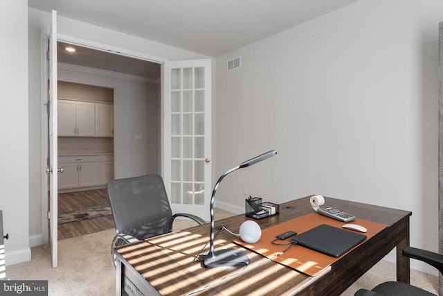 carpeted office with ornamental molding