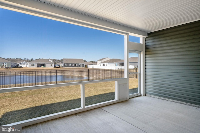 unfurnished sunroom with a water view