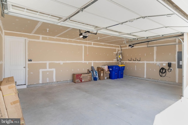 garage featuring a garage door opener and electric panel