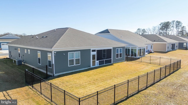 back of property featuring a sunroom, cooling unit, and a lawn