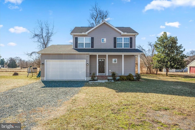 view of front property with a garage, a front lawn, and covered porch