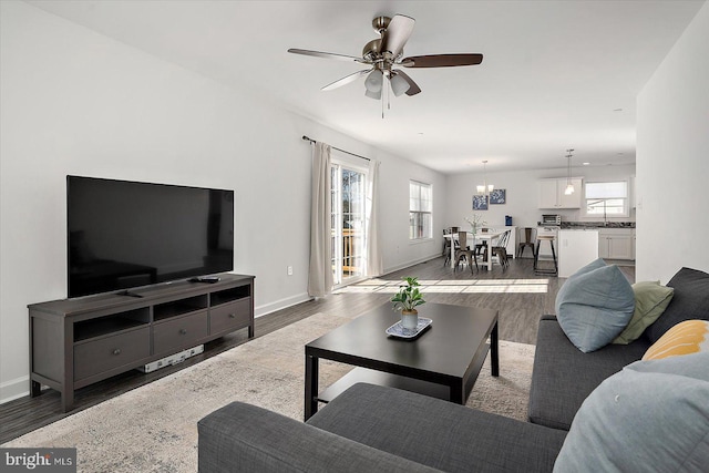 living room featuring dark hardwood / wood-style flooring and ceiling fan