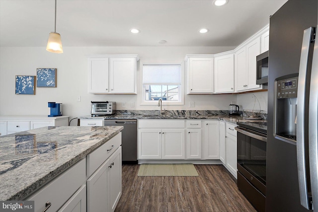 kitchen with stainless steel appliances, sink, and white cabinets